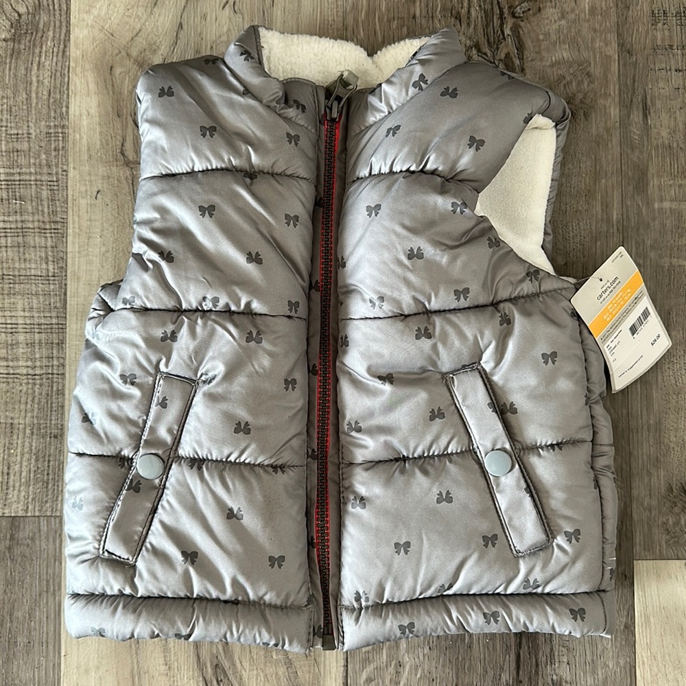 12 month zip up vest. New with tags
